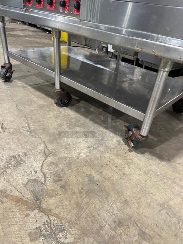 Commercial stainless steel countertop flat griddle with thermostatic controls, back and side splash, undershelf stand, and casters.
