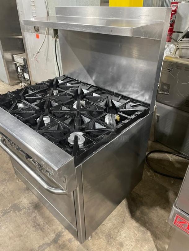 Southbend 4364D stainless steel 6-burner range/oven combo with backsplash, overhead salamander shelf, and wired rack.