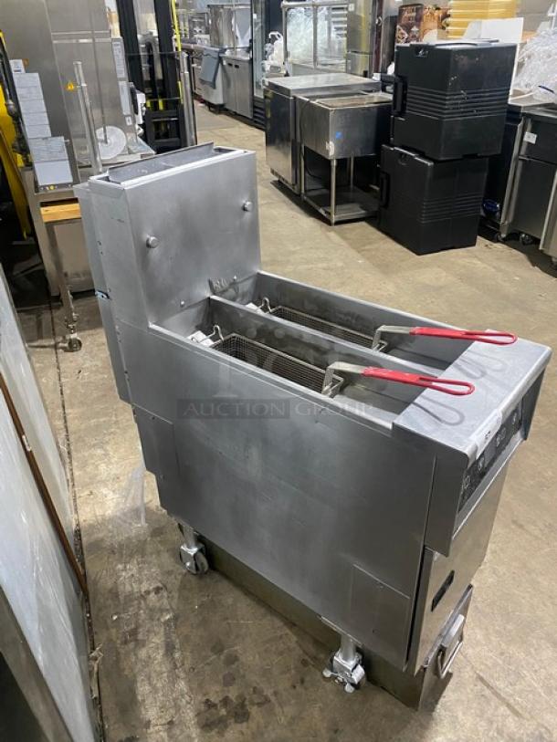 Pitco SFSSH55TRJS stainless steel deep fat fryer, 50 lb split-tank, digital controls, natural gas, on casters, with fry baskets.