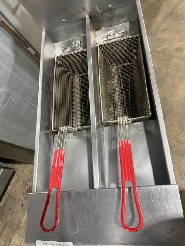 Pitco SFSSH55TR-JS stainless steel 50 lb. split-tank deep fryer with digital controls, fry baskets, and casters.