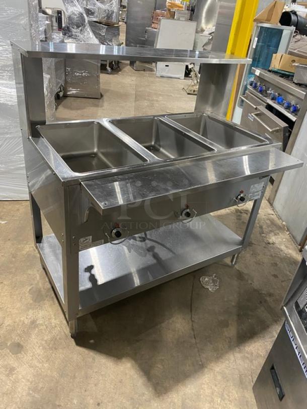 Duke Manufacturing AeroHot 3-well steam table with serve-over shelf, tray slide, undershelf; stainless steel, electric, model E303SWM.
