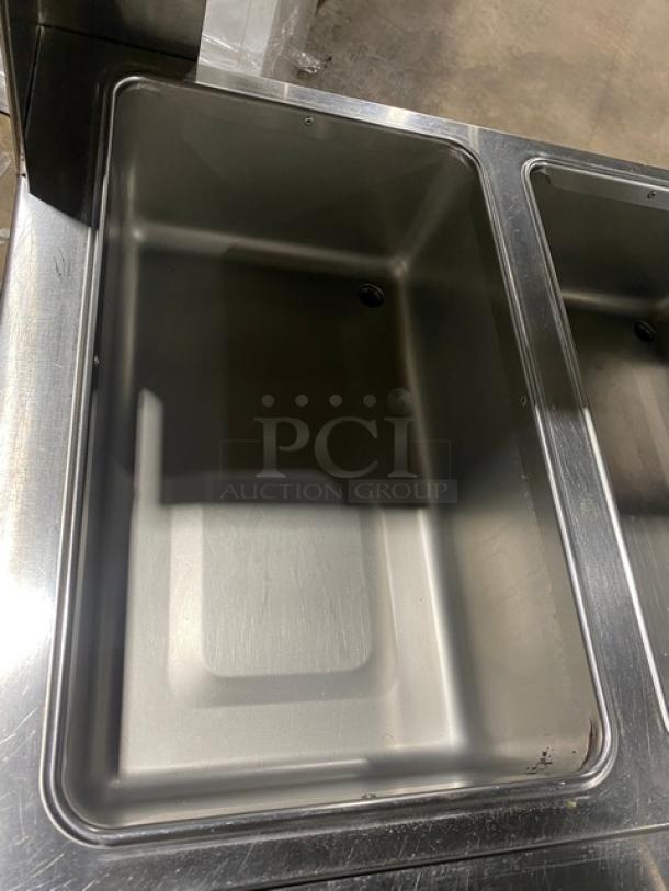 Duke AeroHot Series electric 3-well steam table with serve-over shelf, rear tray slide, and undershelf. Model E303SWM. Stainless steel.