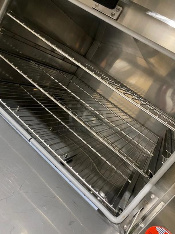 Commercial stainless steel 3-compartment seafood/rice steamer cabinet with individual controls and wired oven racks.