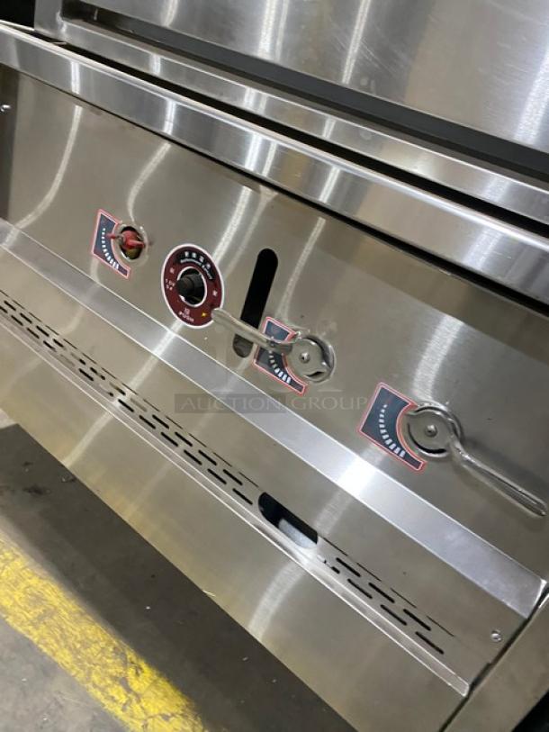 Stainless steel 3-compartment natural gas seafood/rice steamer cabinet with individual controls and wired oven racks.
