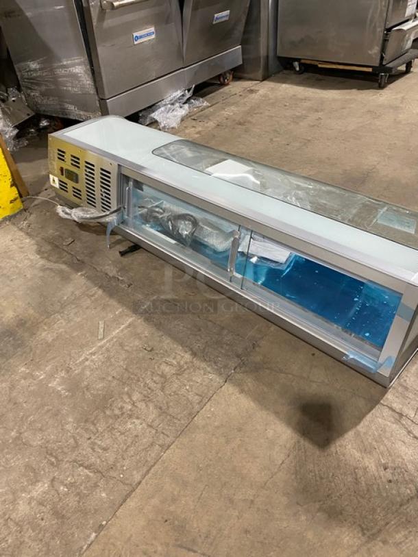 New Marchia stainless steel 53" curved glass sushi display, model MSU150S, with LED lights, rear sliding doors, and hotel pans.