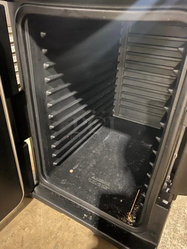 Cambro Ultra Series black front-loading insulated food pan carrier, commercial grade, visible interior racks, used condition.