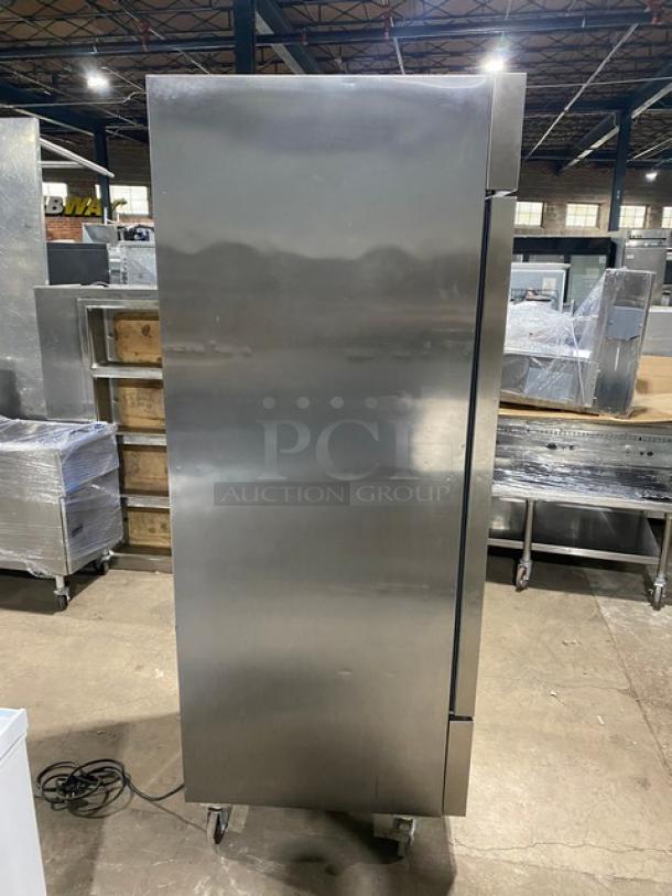Artic Air AF23 stainless steel single door reach-in freezer with poly-coated wire racks, on casters, in good condition.