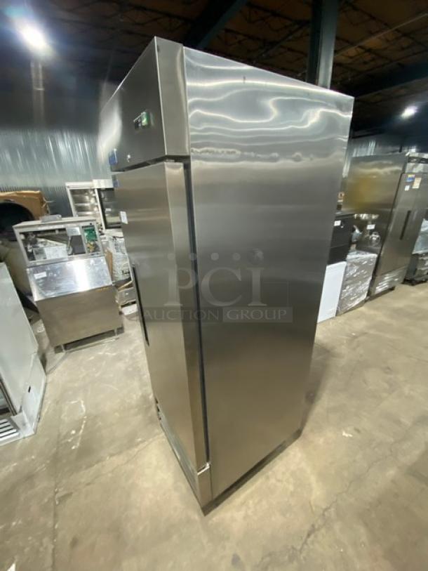 Artic Air AF23 commercial stainless steel single door reach-in freezer with poly-coated wire racks, on casters.