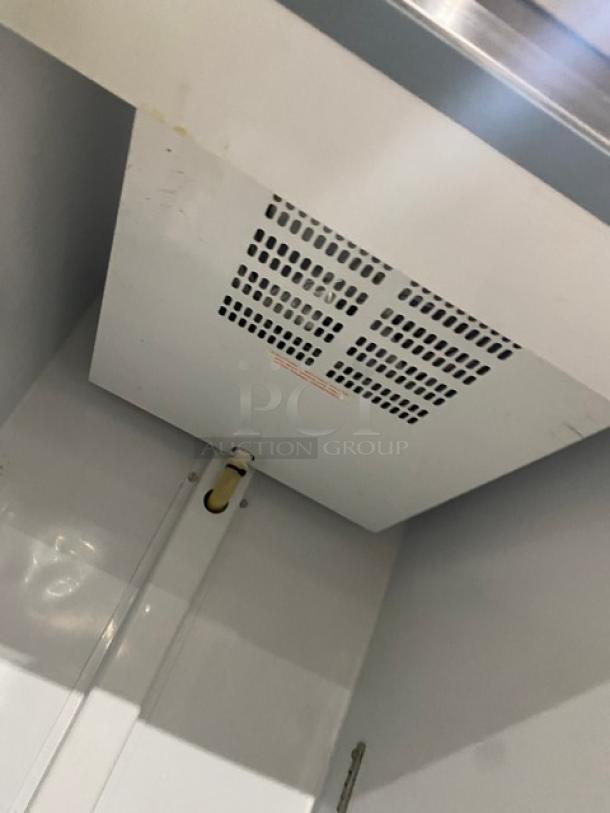 Artic Air AF23 commercial stainless steel freezer interior view, poly-coated wire racks, 115V, on casters.