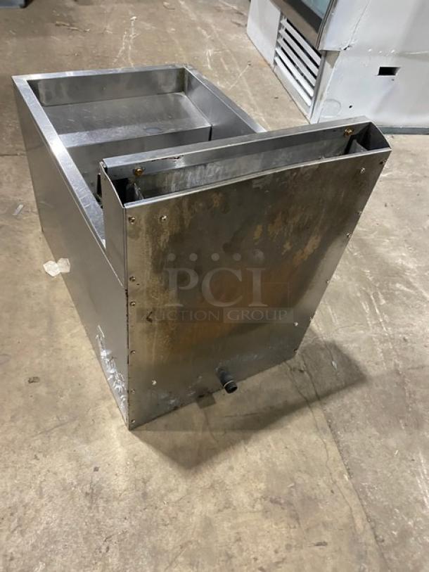 Globe stainless steel countertop natural gas fryer with backsplash and basket hanger. Shows signs of wear. Suitable for commercial use.