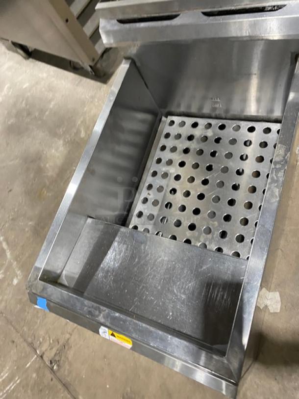 Globe stainless steel natural gas countertop deep fryer with backsplash, basket hanger, and perforated interior.