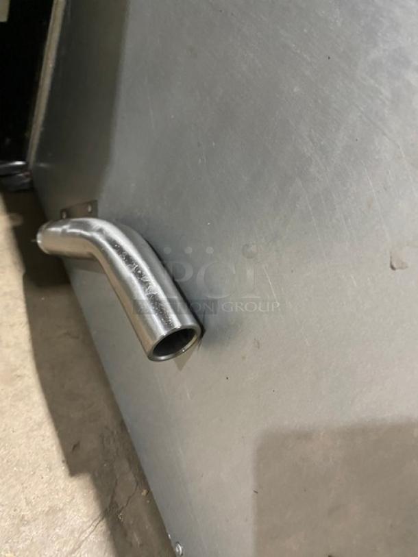 Stainless steel natural gas countertop deep fryer, Globe make, featuring backsplash and basket hanger, shown in used condition.