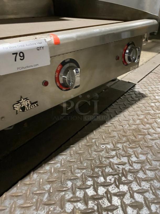 Star Max Series stainless steel electric griddle with thermostatic controls, back and side splash, on legs.