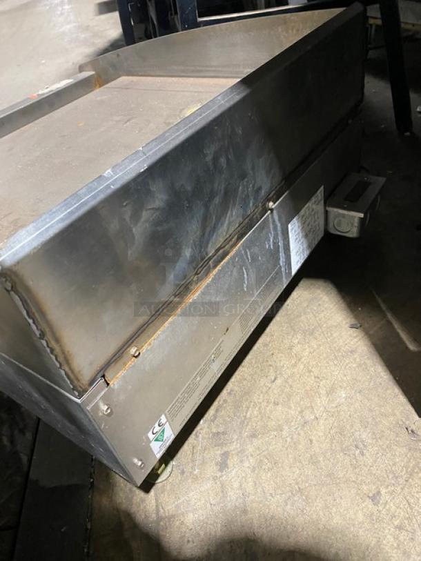 Star Max Series stainless steel electric countertop flat griddle with thermostatic controls, back and side splash, on legs.