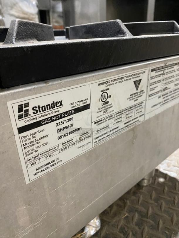 APW Wyott GHPW-2i stainless steel 2-burner gas hot plate. Model: GHPW-2i, SN: 051621606001, on legs. Standex label visible.
