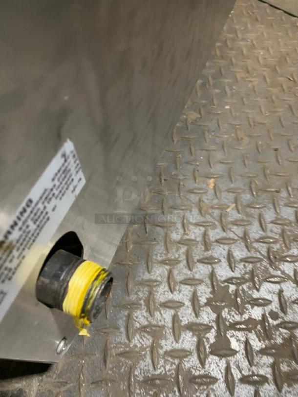 APW Wyott GHPW2i stainless steel countertop hot plate with two burners, gas connection, serial 051621606001, on legs.