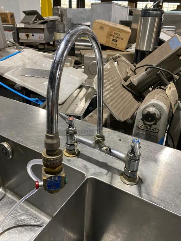 Custom commercial stainless steel double compartment handwashing/prep sink workstation with goose neck swivel faucet, enclosed cabinet base, on legs.
