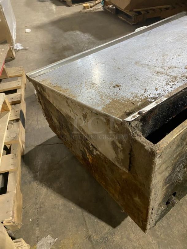 Commercial stainless steel natural gas countertop flat griddle with thermostatic controls, back, and side splash. Visible wear.