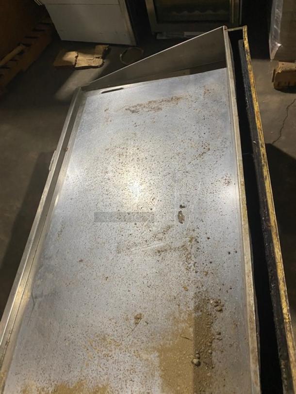 Commercial stainless steel natural gas countertop flat griddle with thermostatic controls, back and side splash, fair condition.