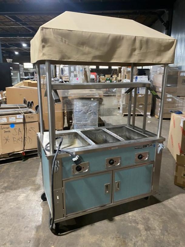 Piper Products stainless steel 3-well hot food table, model 3HF, with sneeze guard, awning, and 2-door cabinet on casters.