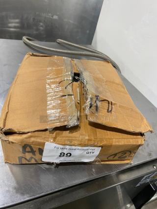 Damaged cardboard box containing American Metalcraft Commercial Stainless-Steel Heavy-Duty Measuring Cup Set, Model MCW-4.