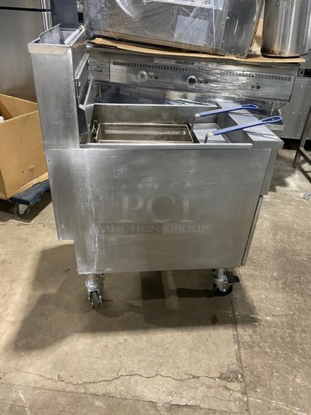 Pitco SG18S commercial fryer, natural gas, stainless steel, with backsplash, basket hanger, fry baskets, on casters.