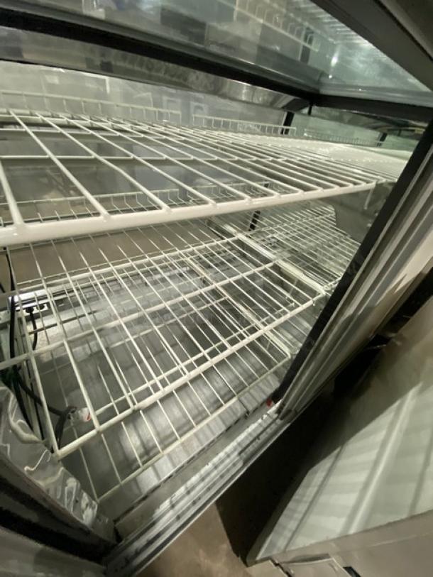 American Metalcraft Model MCW4 white glass refrigerated display case, poly-coated wire racks, rear sliding doors.
