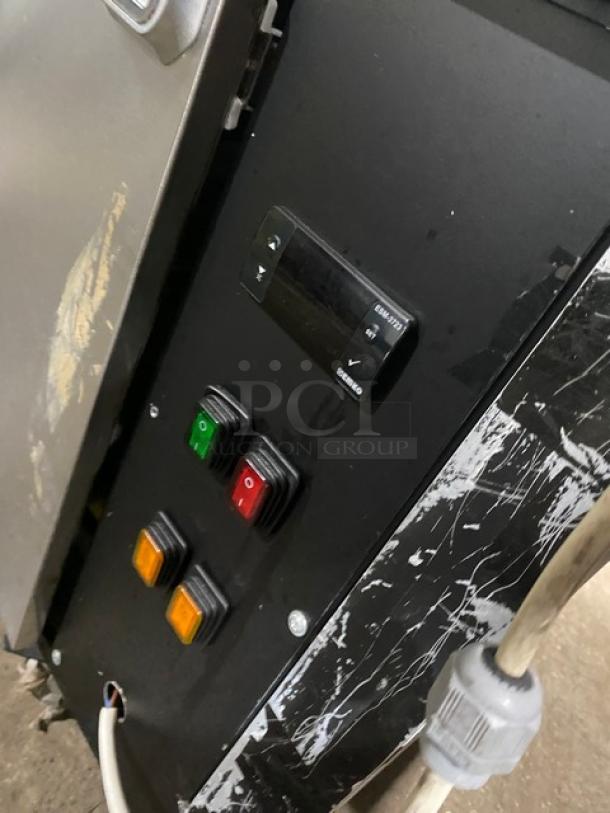 Control panel of a black refrigerated bakery display case, featuring power buttons and a digital display. Glass and interior not visible.