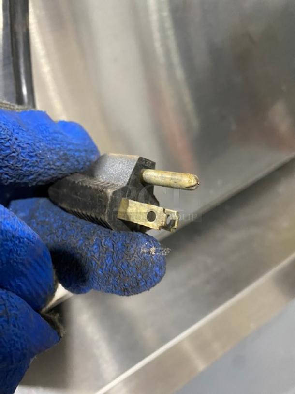 Close-up of a three-prong electrical plug, part of a Star Model 258 commercial stainless steel hot dog roller, 120V.