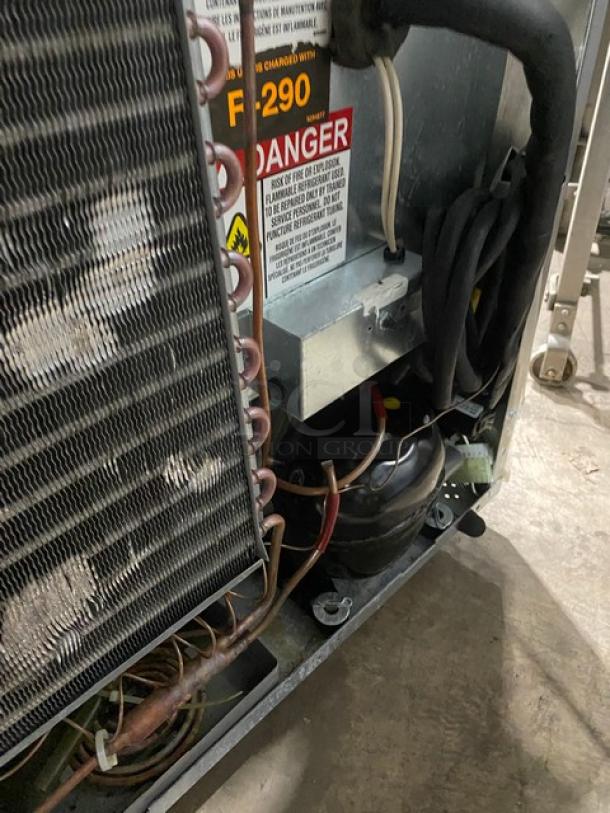 Delfield 406P-STAR2 undercounter refrigerator, stainless steel, 115V, 1 phase, on casters, includes poly coated wire rack, visible warning label.