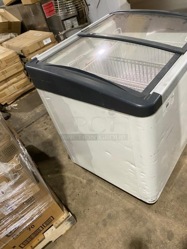 Liebherr EFI2053 curved top freezer with double sliding glass doors, poly-coated wire baskets, on casters, fair condition.