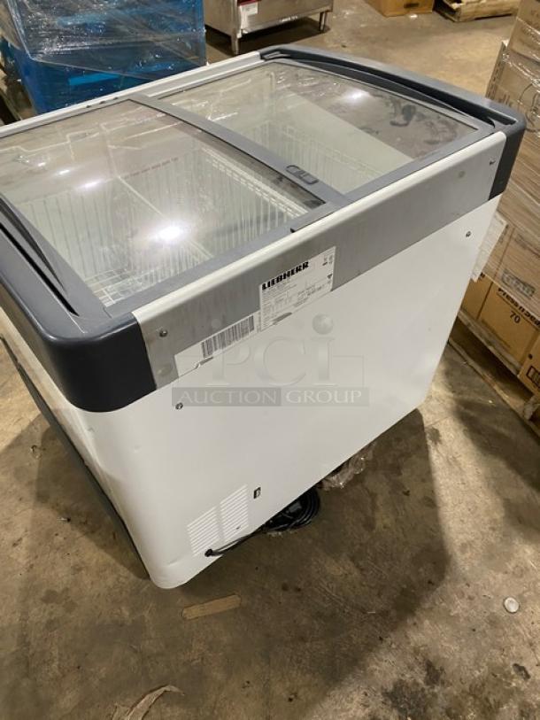 Liebherr commercial white chest freezer with curved top, double sliding glass doors, poly-coated wire baskets, model EFI2053.