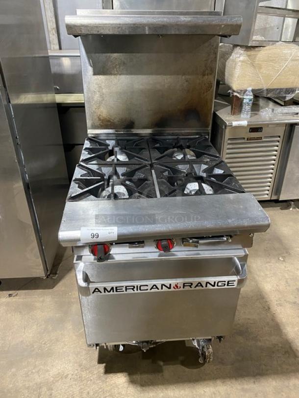 American Range stainless steel 4-burner gas range/oven combo with backsplash, salamander shelf, and wired rack on casters.