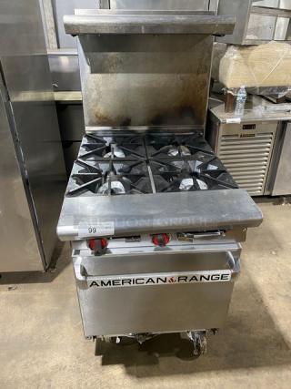American Range stainless steel 4-burner gas range/oven combo with backsplash, salamander shelf, and wired rack on casters.