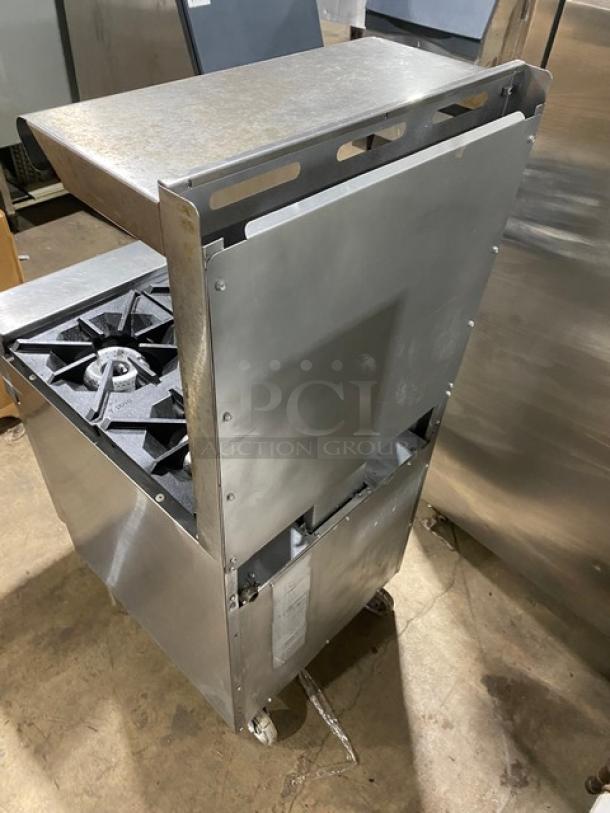 American Range stainless steel 4-burner range/oven combo, natural gas, with backsplash, overhead shelf, and casters, used.