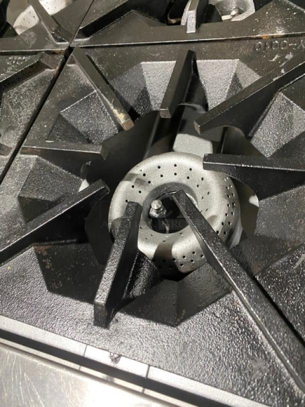 American Range 4-burner natural gas stove, featuring durable cast iron grates, part of a commercial oven range combo.