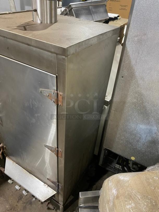Commercial stainless steel natural gas smokehouse oven with right-side hinged door, on legs. Used condition.
