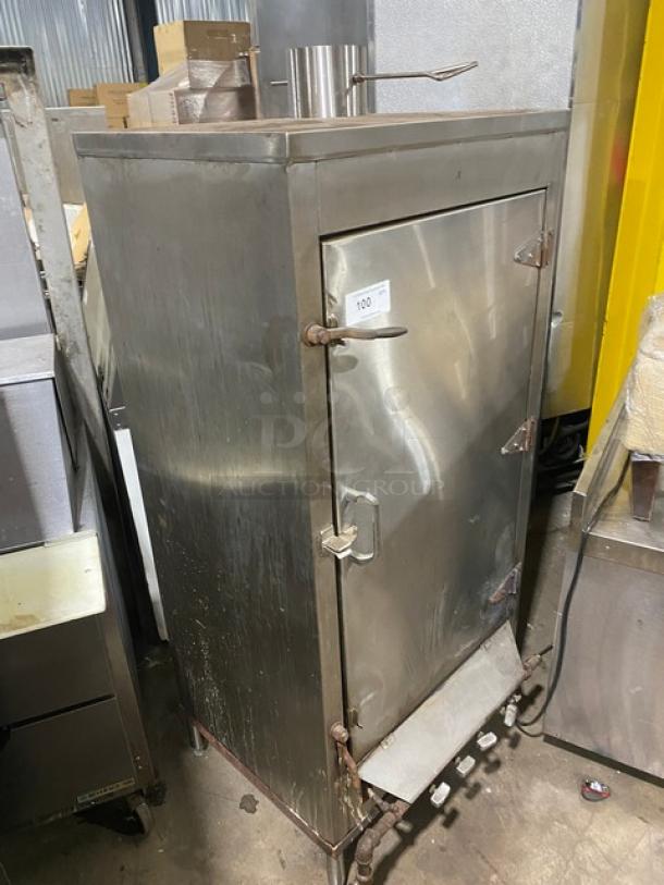 Commercial stainless steel natural gas smoker oven with right-side hinged door and legs, used condition.