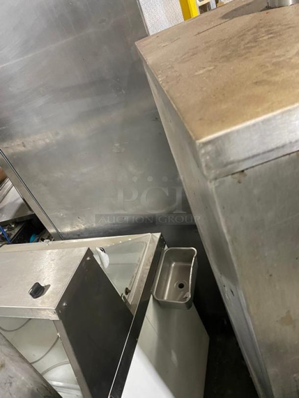 Commercial stainless steel natural gas smoker oven, right-side hinged door, mounted on legs. Used, good condition.
