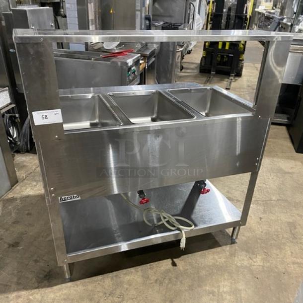 Duke AeroHot E303SWM 3-Well Hot Food Table, stainless steel, electric, with serve-over shelf, rear tray slide, and undershelf.