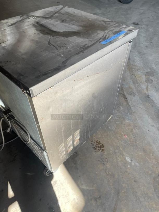 Master-Bilt Fusion Series stainless steel undercounter refrigerator, model UR27, with poly coated wire rack, on casters.