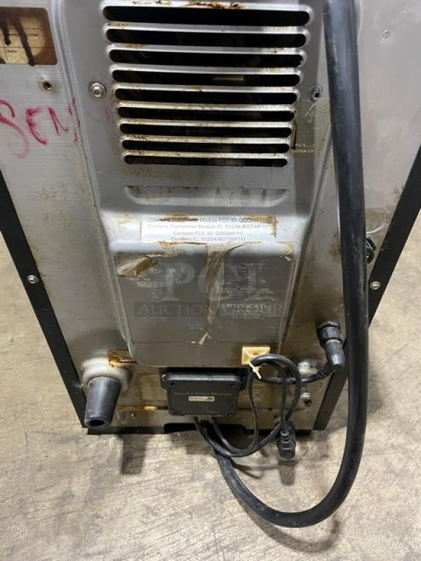 MerryChef Eikon E2S rapid cook oven back view, showing vents and a power cord, with signs of wear and markings.