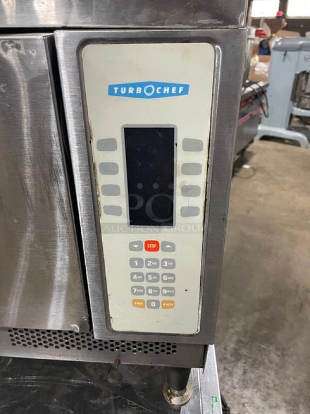 TurboChef NGC stainless steel rapid cook oven with digital controls on stainless equipment cart. Ventless, electric-powered.