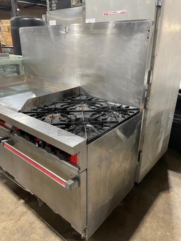 Vulcan commercial stainless steel range, featuring split top 4-burner griddle, double oven, backsplash, and wired racks.