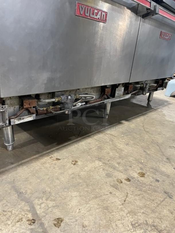 Vulcan commercial stainless steel griddle and double oven combo. Features 4 burners, split top, backsplash, and oven racks.
