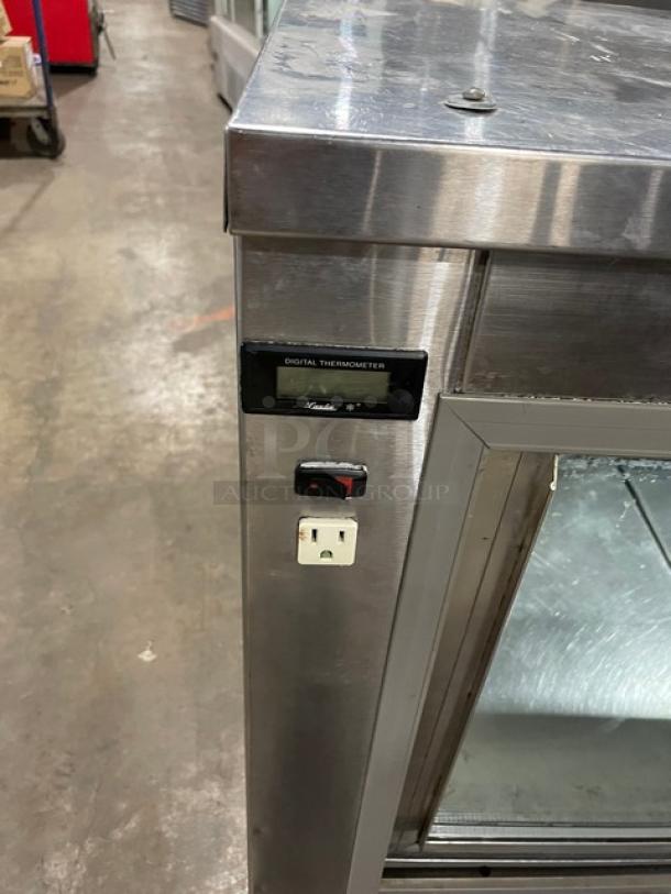Leader commercial stainless steel refrigerated display case with slanted glass, rear sliding doors, and digital thermometer.