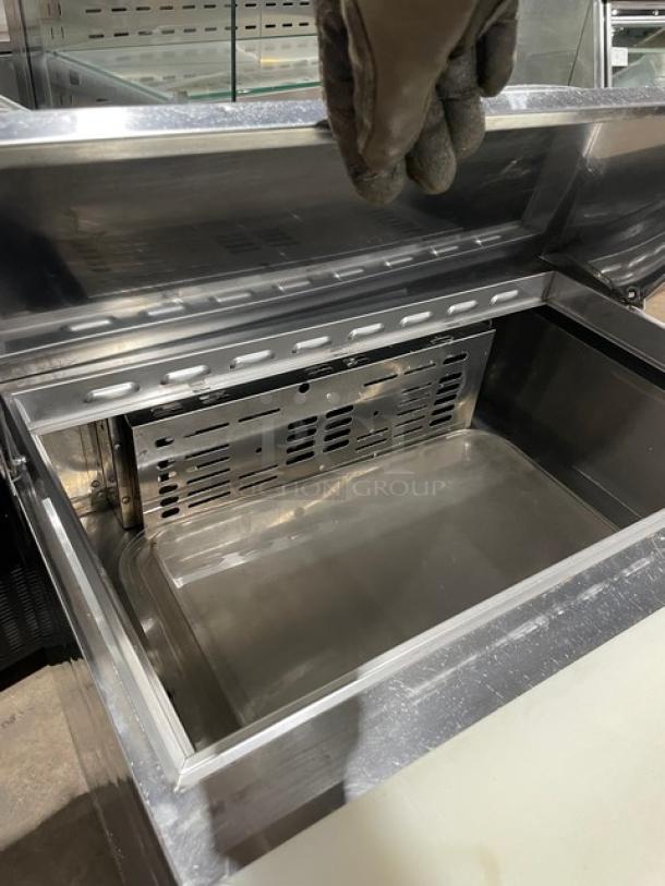 Turbo Air MST-28 stainless steel refrigerated salad prep table with cutting board, poly-coated wire rack, on casters.