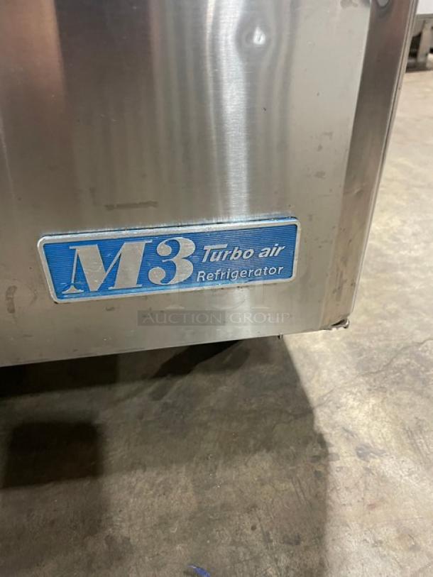 Turbo Air M3 Series stainless steel refrigerated prep table, model MST-28, with cutting board and wire rack, on casters.