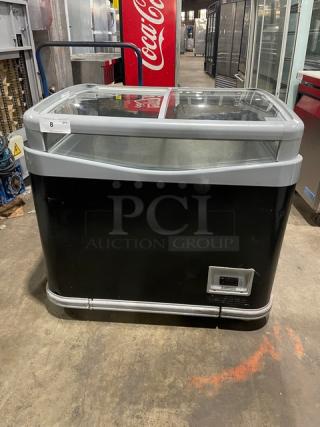 AHT Commercial Black Glass Top Ice Cream Merchandiser Freezer with double sliding lid and casters, in good condition.