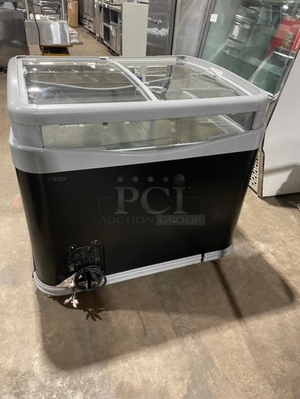 AHT commercial black glass top ice cream merchandiser display chest freezer with double sliding lid, on casters, in good condition.